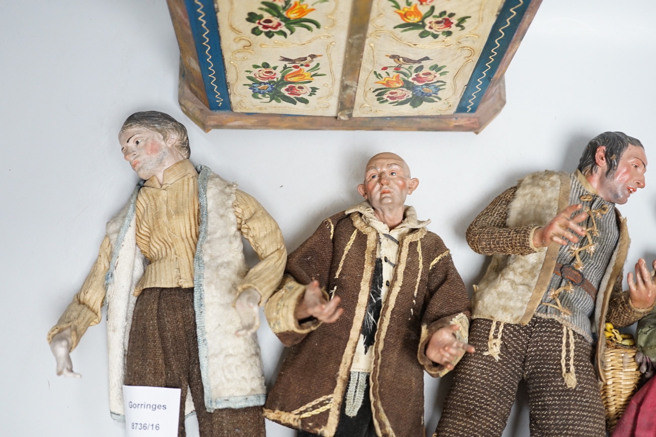 Four 18th/19th century Neapolitan painted wood or terracotta crèche figures, tallest 31.5cm and a 20th century miniature Bauernschrank